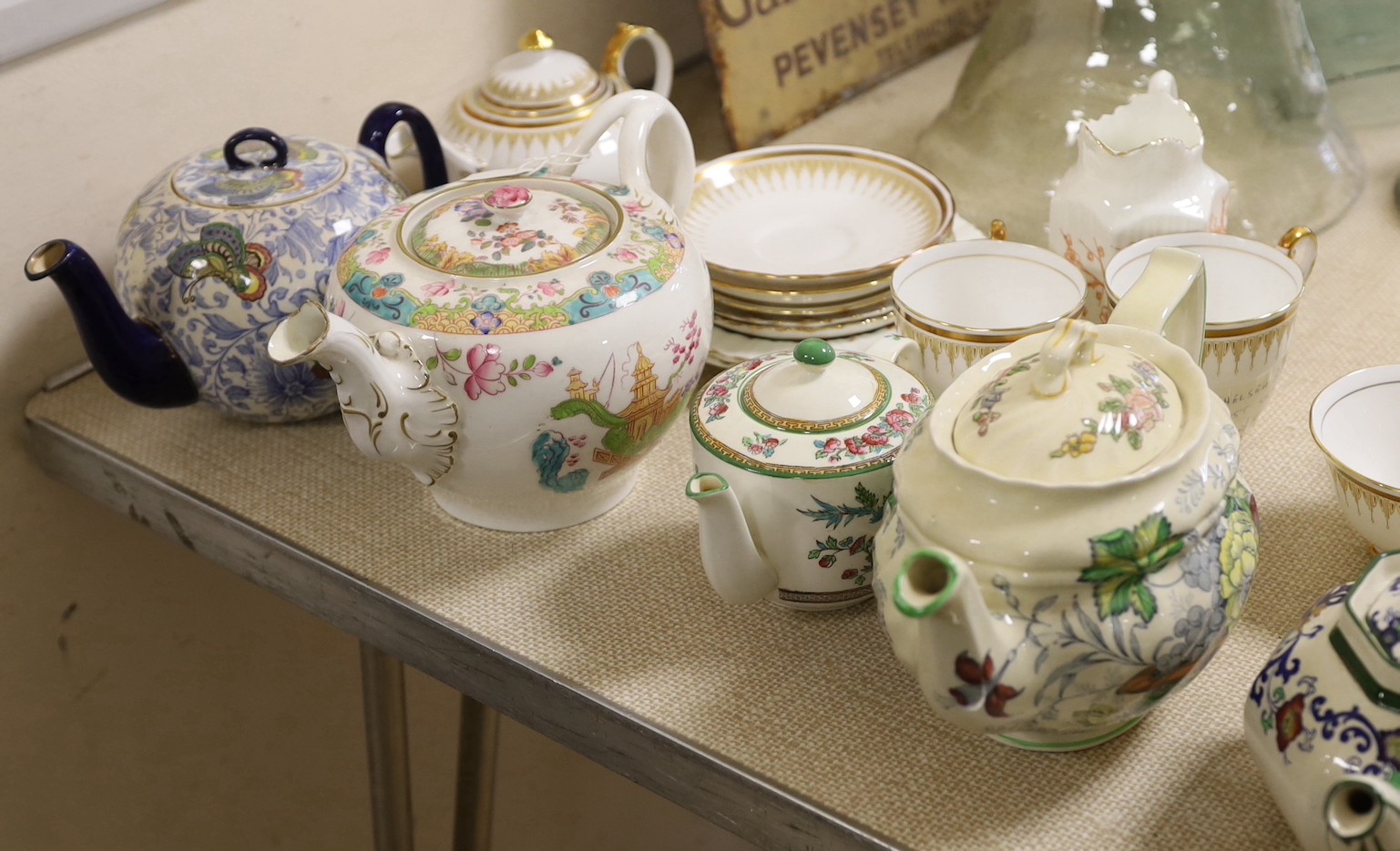 A quantity of tea pots and wares including Doulton, Royal Chelsea, etc.